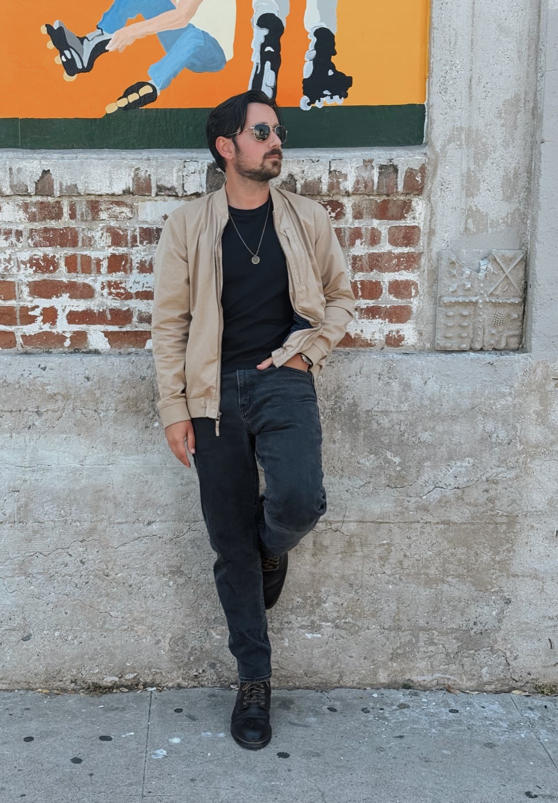 Dylan Kline in front of a brick mural